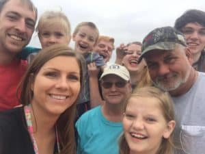 Shirley Kisor is shown above center (with ball cap) with her husband and some of your children and grandchildren at the Perry Fair.