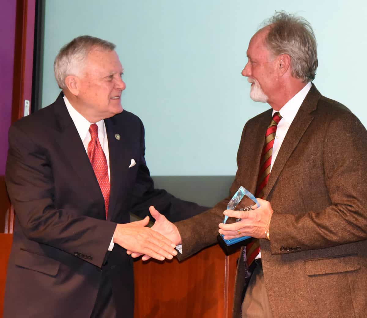 Georgia Governor Nathan Deal (l) is shown above presenting Daniel Linginfelter, Sr. (r) with his Distinguished Alumni Award.