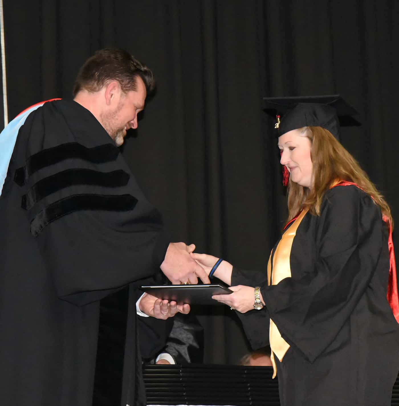 Jamie Campbell of Americus, a Presidential Honor Graduate, earned an AAS in Accounting. She is shown receiving her diploma from SGTC President Dr. John Watford.