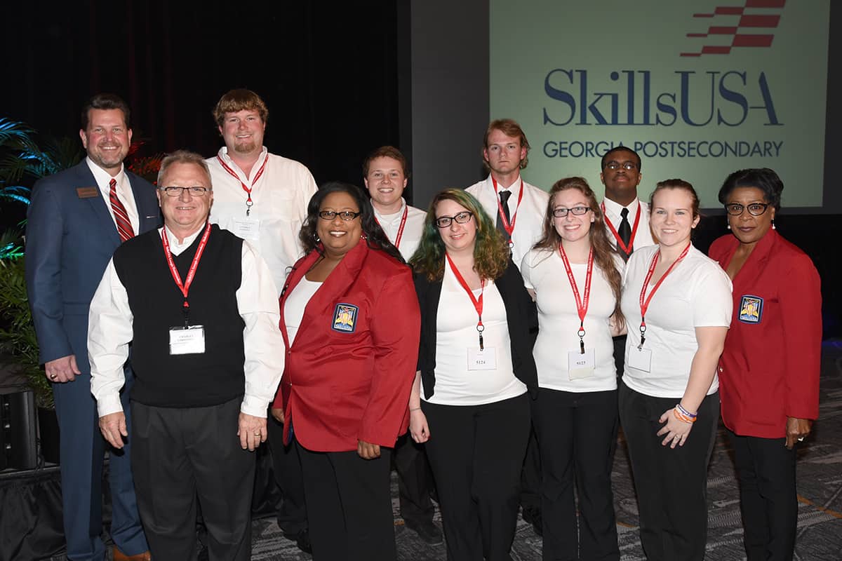 On the front row from left to right are SkillsUSA advisors Charles Christmas and Dr. Michele Seay, SkillsUSA competitors Destiny Baker, Rachael Johnson, and Kaitlyn Carpenter, and SkillsUSA Advisor Cynthia Carter. On the back row from left to right are SGTC President Dr. John Watford and SkillsUSA competitors Stephen Simmons, Brennan Morris, William Manning, and Nathan Prince. Not pictured are Annie Streeter, Josiah Copeland, Stephaine Tyson, and Bailey Mills.