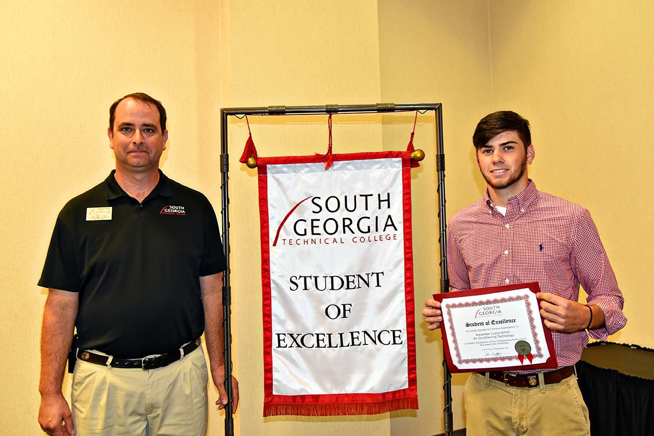 Alex Smith (RIGHT) is pictured with his nominating instructor Glynn Cobb. The Student of Excellence banner will hang in the Air Conditioning Technology program area until next month’s Student of Excellence is named.