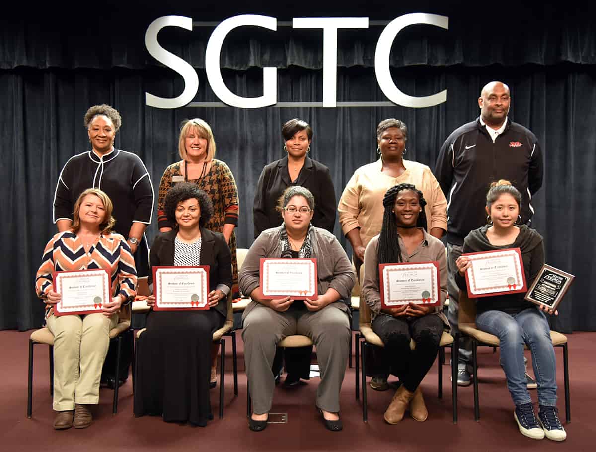 Sitting from left to right are Student of Excellence nominees Hope Griggs, Adrienne Clayton, Angelica Sims, Kayla Bowens, and winner Kanna Suzuki. Standing from left to right are nominating instructors: Brenda Hudson Boone, Donna Lawrence, Andrea Ingram, Mary Cross and Travis Garrett.