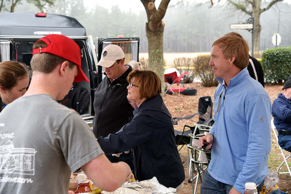 Chamber of Commerce members Jimmy Whaley (left), Carolyn Wright (center), and Judge William Rambo (right) hand out plates of hamburgers and hotdogs to attendees at South Georgia Technical College’s Alumni and Sophomore Day Tailgate event recently. The Chamber of Commerce, along with Imerys Refractory Minerals, sponsored the event and fed over 200 people.