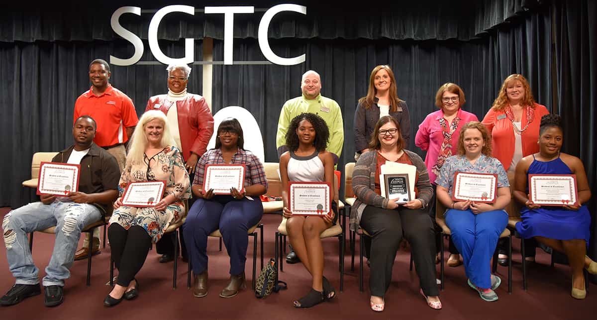 Student of Excellence nominees and nominating instructors pose for a picture with their certificates. Seated left to right: SGTC Student of Excellence nominees Timothy Payne, Merleen Cortez, Shaketia Tyson, Aleshia Curinton, Valorie P. Rikard and Brittany Mutcherson. Standing left to right: Nominating Instructors Xavier Jackson, Dorothea Lusane-Mckenzie, Ricky Watzlowick, Victoria Kelley, Diana Skipper and Jennifer Childs. Teresa McCook is not pictured.