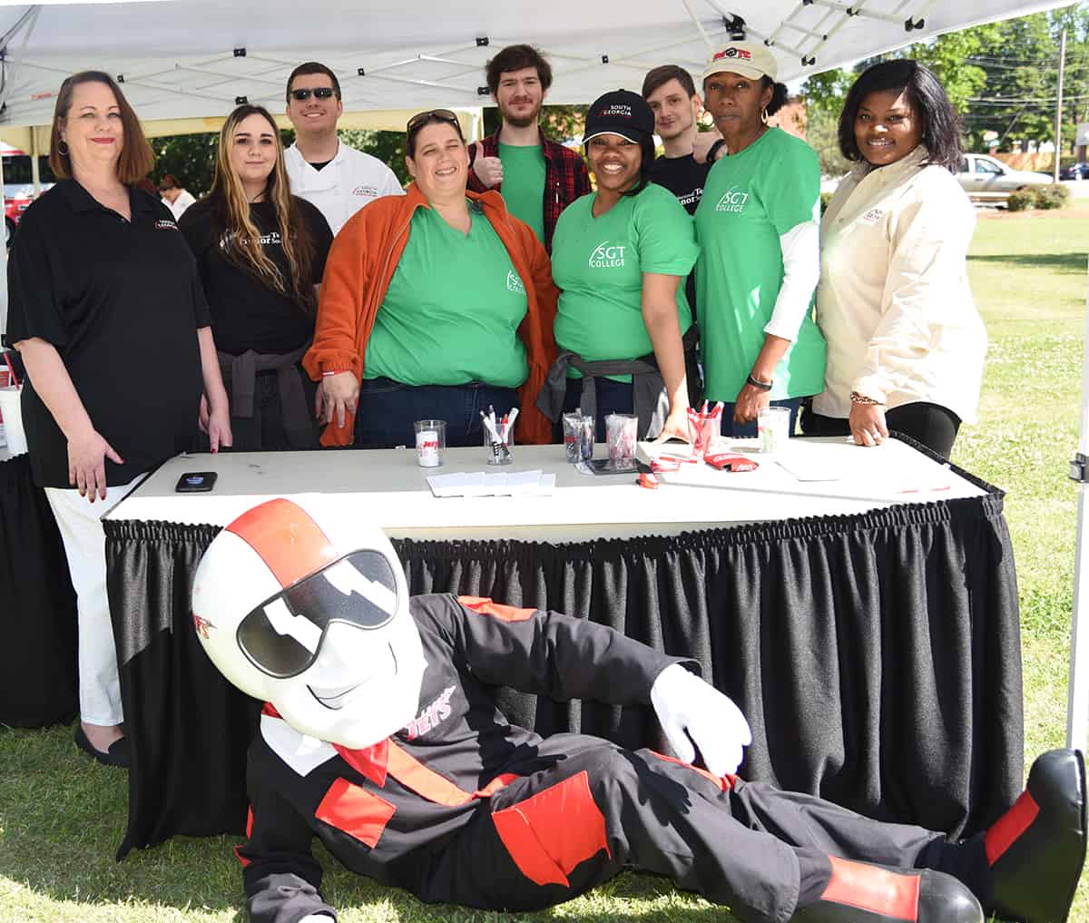 South Georgia Technical College Admissions Coordinator Kari Bodrey and English Instructor Katrice Taylor are shown above with some of the National Technical Honor Society students who helped with the Spring Take Off event.  SGTC’s mascot, ACE is also shown with the group.