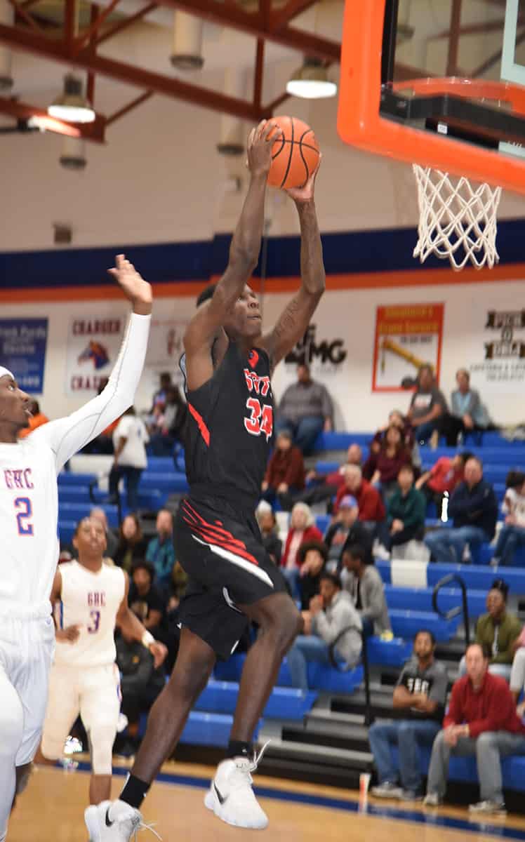 South Georgia Tech's Marquel Wiggins, 34, goes to the basket for a dunk against Georgia Highlands in the NJCAA Region XVII Tournament in Rome, GA.