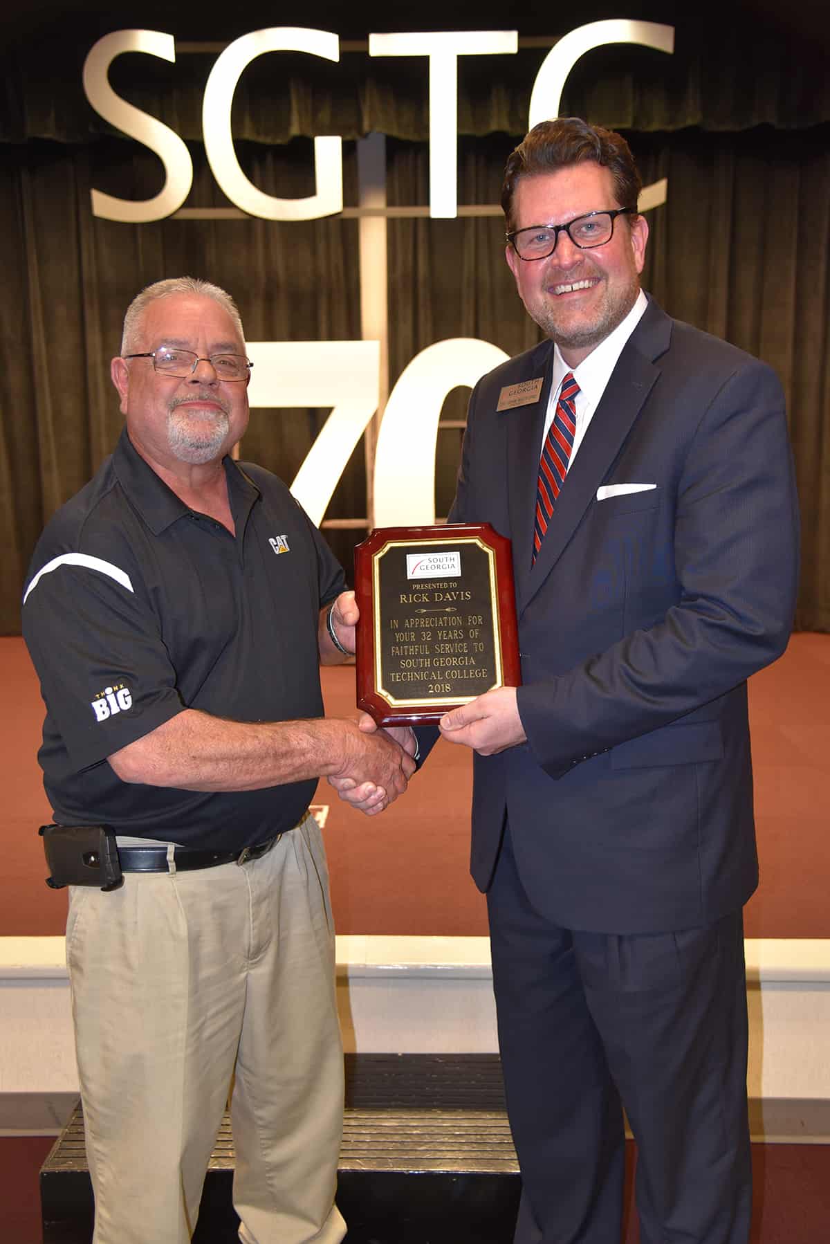 Dr. John Watford (r) is shown above presenting Rick Davis with a plaque in honor of his more than 30 years of service with South Georgia Technical College.