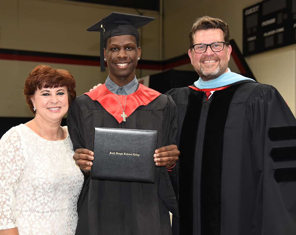 South Georgia Technical College President Dr. John Watford and his wife, Barbara is shown above with South Georgia Technical College’s Marquel Wiggins from Macon County who earned an Associate Degree in Sports and Fitness Management.  Wiggins, who played for the SGTC Jets basketball team, has signed a letter of intent to play at Talladega University in Talladega, Alabama.