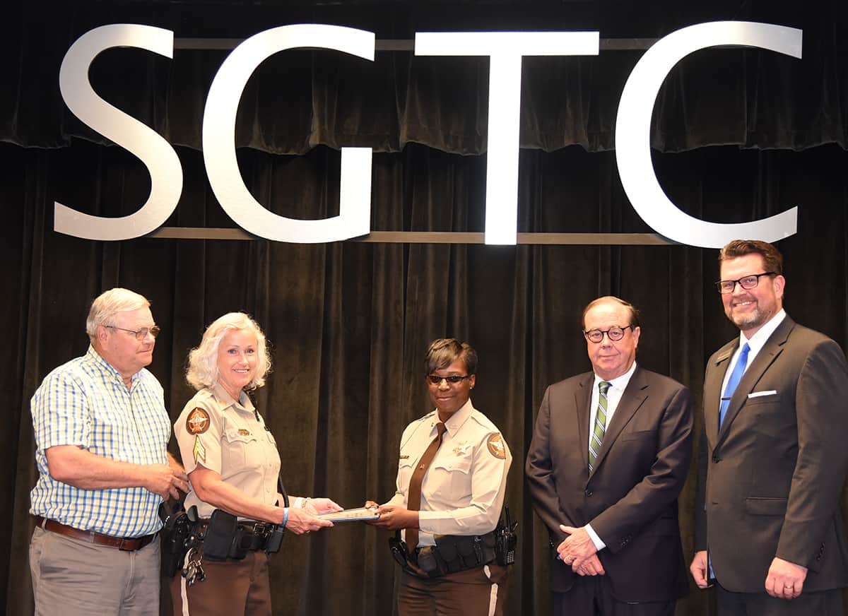 Paul and Sharon Smith Johnson are shown above presenting the Smarr-Smith Criminal Justice Scholarship to Sumter County Sheriff Deputy Antoinette Johnson as SGTC Foundation Trustee and retired Judge George Peagler, and SGTC President Dr. John Watford look on.