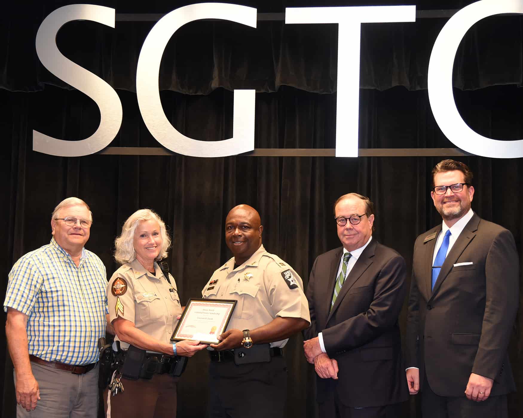 Paul and Sharon Smith Johnson are shown above presenting Dooly County Sheriff Office Captain Emerson R. Lundy with the Smarr-Smith Criminal Justice Scholarship. SGTC Foundation Trustee and retired Judge George Peagler and SGTC President Dr. John Watford are also shown.