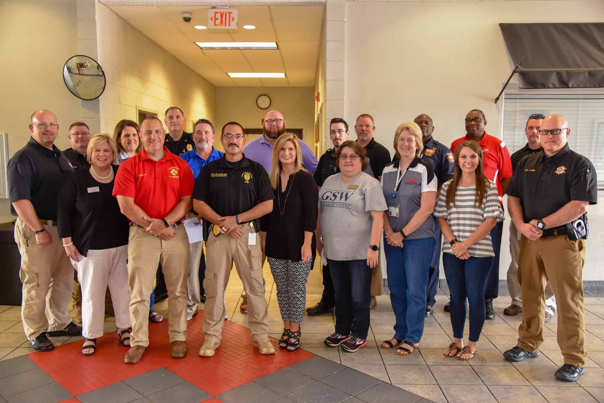 Representatives from participating agencies are shown together after a planning meeting for the upcoming emergency response training drill. 