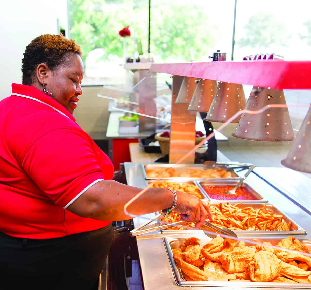 Shirley Trice manning the food line for the lunch meal at SGTC.