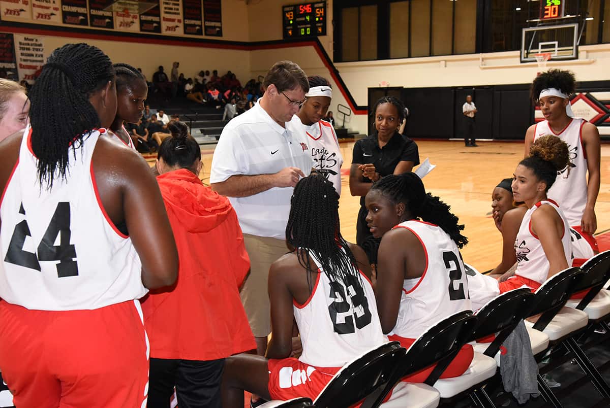 South Georgia Tech Lady Jets head coach James Frey and Assistant Coach Kezia Conyers plan strategy during a time-out against Albany State.