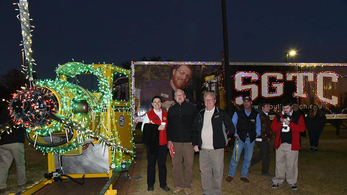 Members of the South Georgia Technical College Aviation Maintenance faculty are shown above with one of the college’s aviation trainers displayed in lights.