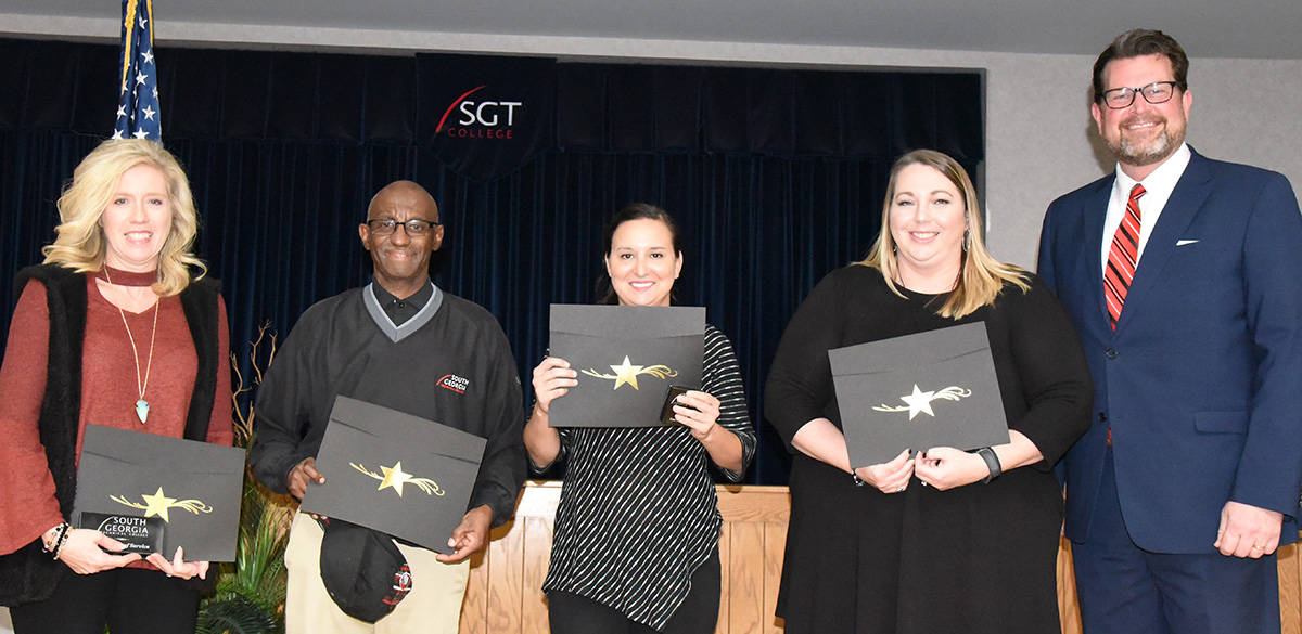 The SGTC Crisp County Center employees recognized for their years of service shown above are: (l to r) Teresa Jolly, Keith Lewis, Valerie Hines, and Kelly Everett.  SGTC President Dr. John Watford is shown congratulating them on their service.