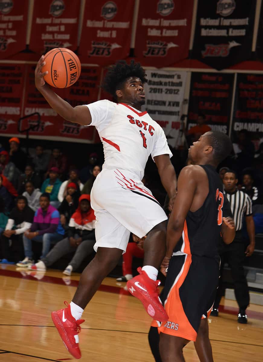 Jaylan McKinney, 1, is shown driving toward the basket.