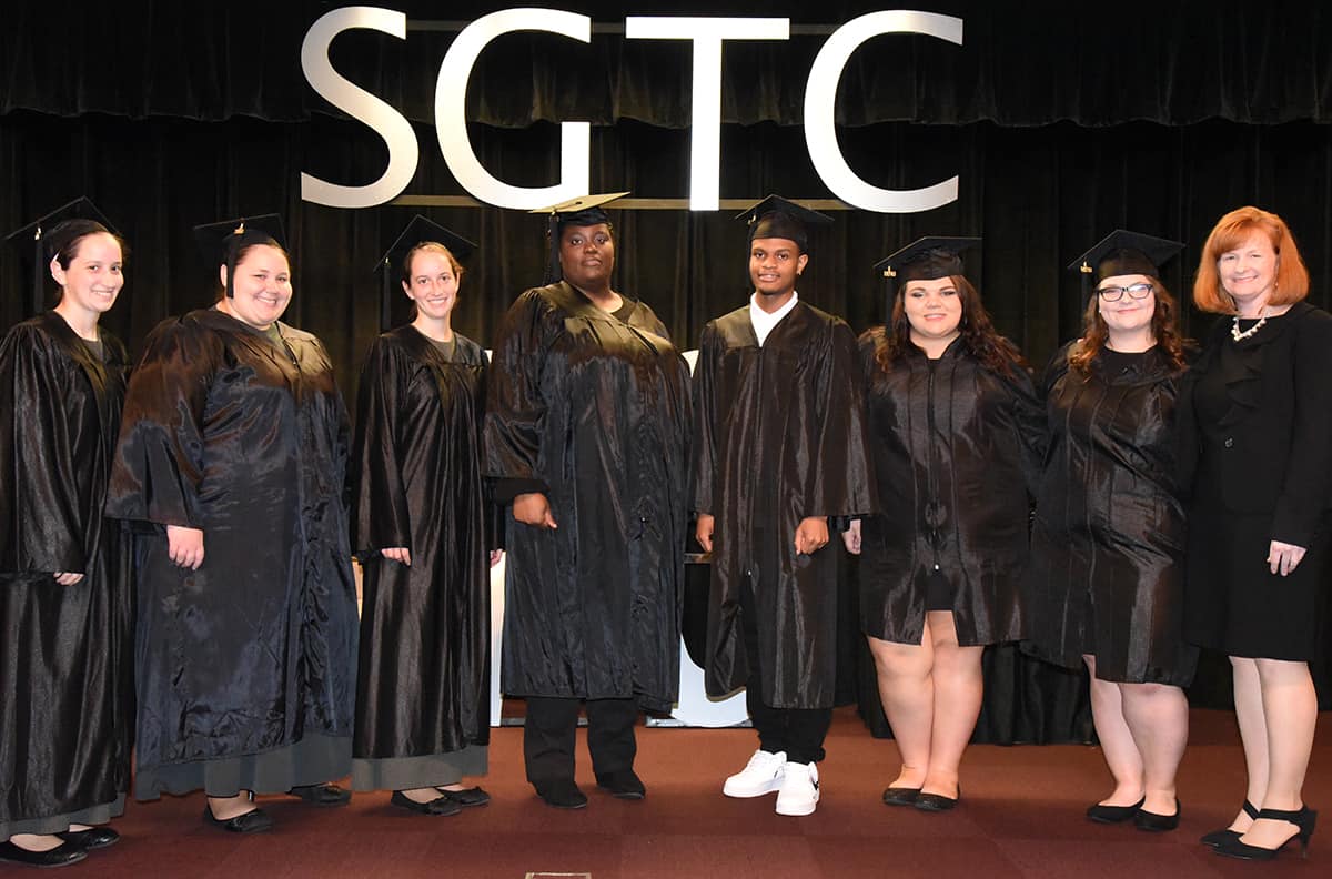 Macon County GED graduates are shown above with instructor Angie Kauffman.