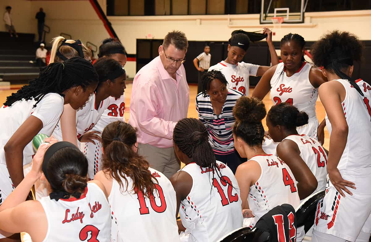 South Georgia Technical College head coach James Frey and Assistant Coach Kenzia Conyers are shown talking with the players during a time-out.