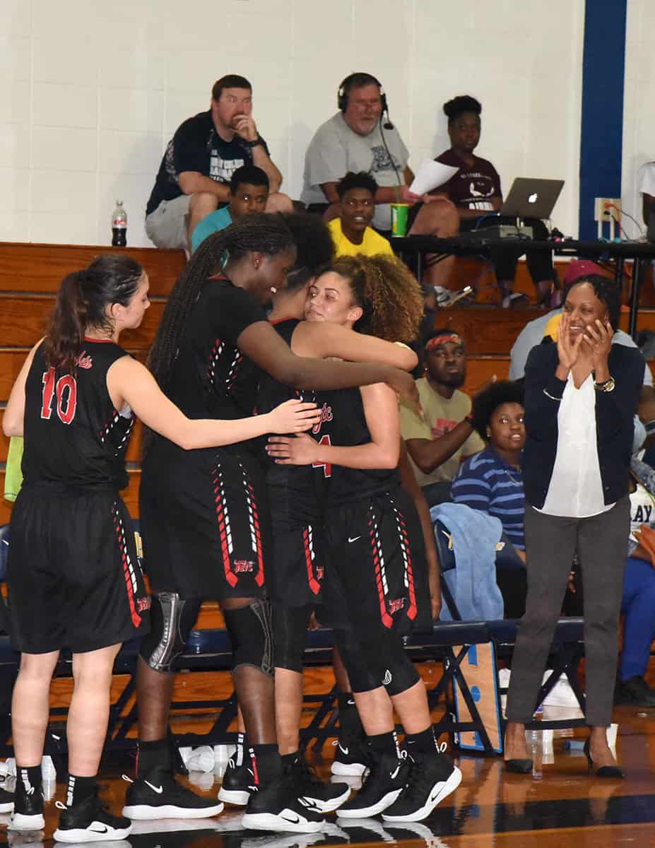 The Lady Jets congratulate Alyssa Nieves, 4, after a record setting game against Andrew College.