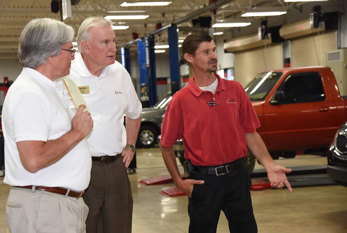 W.T. Standard and Bob Evans are shown talking with SGTC Automotive Repair Instructor Brandon Dean in the college’s automotive repair lab.