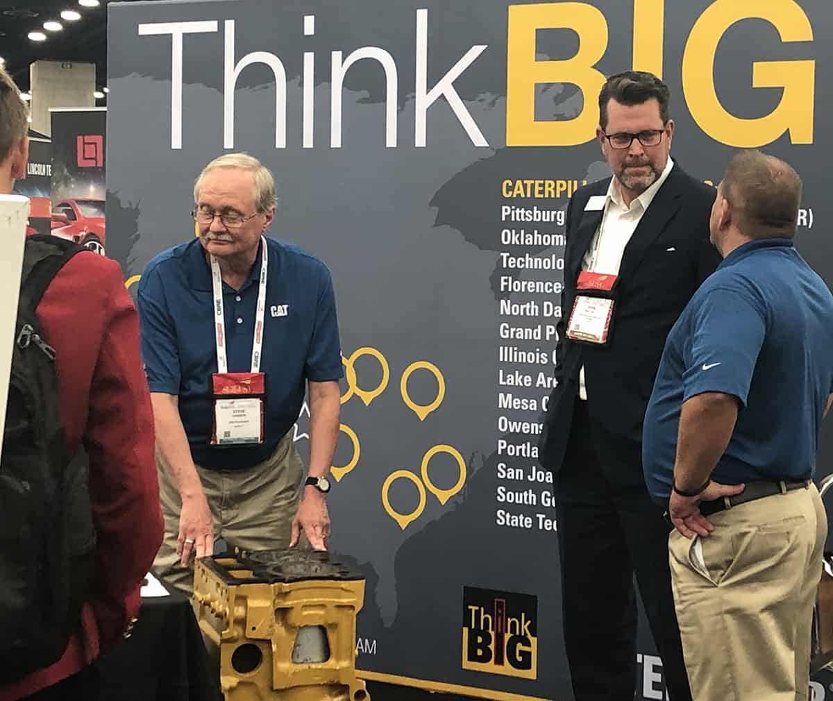 SGTC President Dr. John Watford is shown above talking with Caterpillar representatives at the ThinkBIG booth.