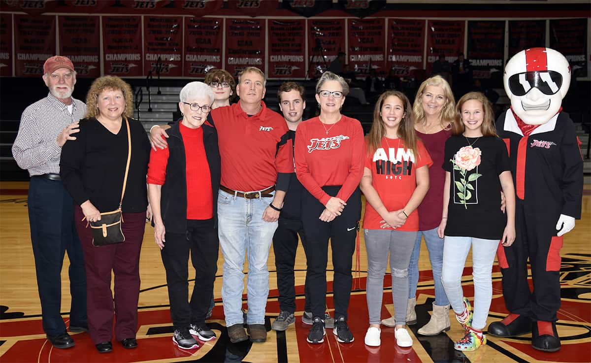 The family of Pete Arrington was recognized during halftime of the Jets vs. Wake Tech game at the inaugural Pete Arrington Classic. Pictured along with “Ace” the SGTC Jets mascot are (l-r) Wayne Arrington, Jody Arrington, Martha Arrington, Connor Rhyne, Darrell Arrington, Hank Arrington, Terri Battle, Gracie Arrington, Judy Arrington, and Emma Arrington.