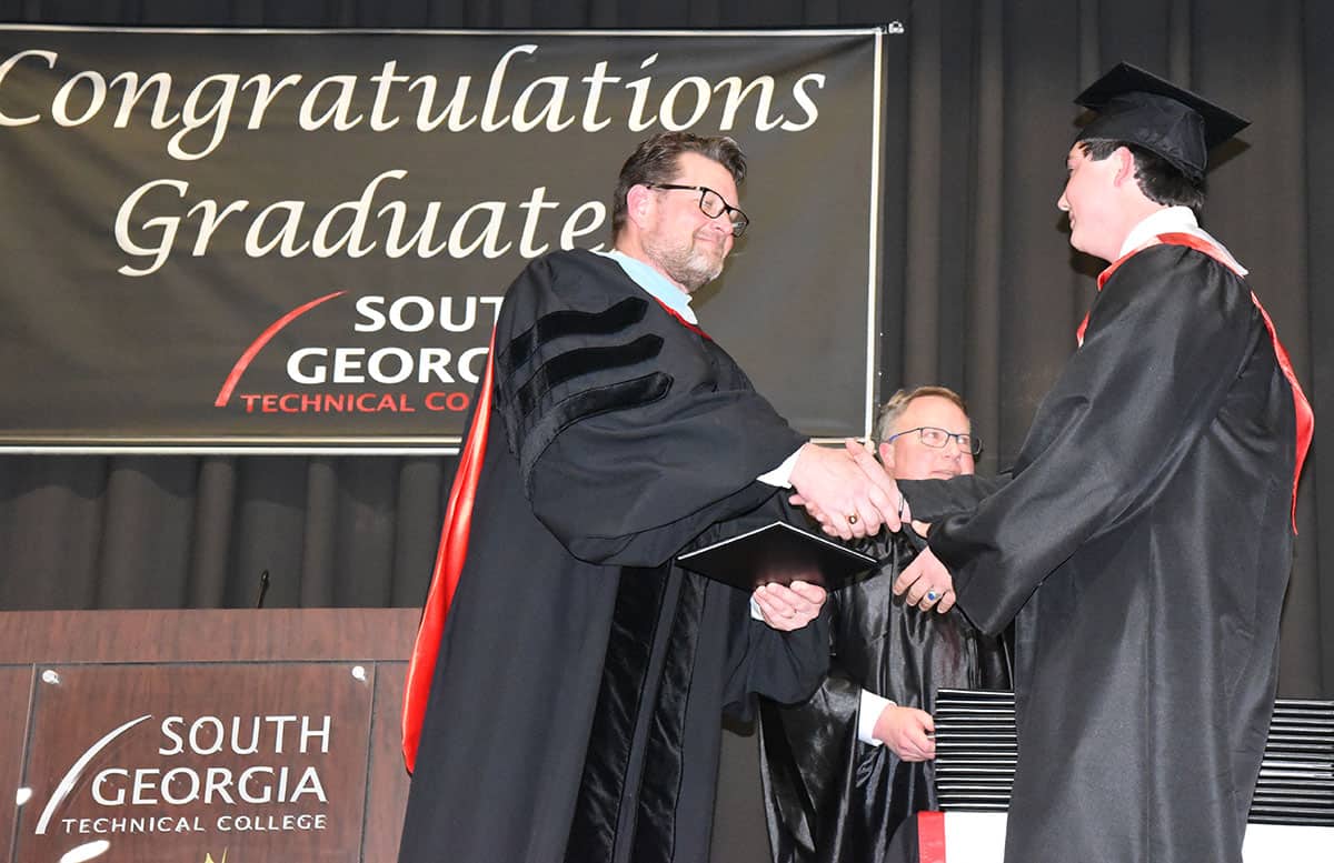 topher Jaycob Averett of Ellaville is shown above receiving his diploma from SGTC President Dr. John Watford.  Averett was an Honor Graduate and earned his AAS and Diploma in Accounting.