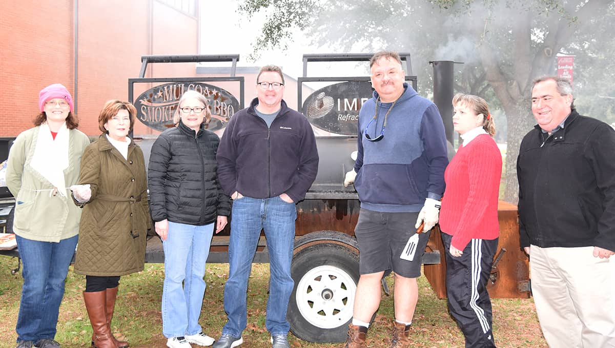 Members of the Americus-Sumter County Chamber of Commerce are shown above in front of the big grill where they grilled the hot dogs and hamburgers for the large crowd at the SGTC Alumni-Sophomore Day event.