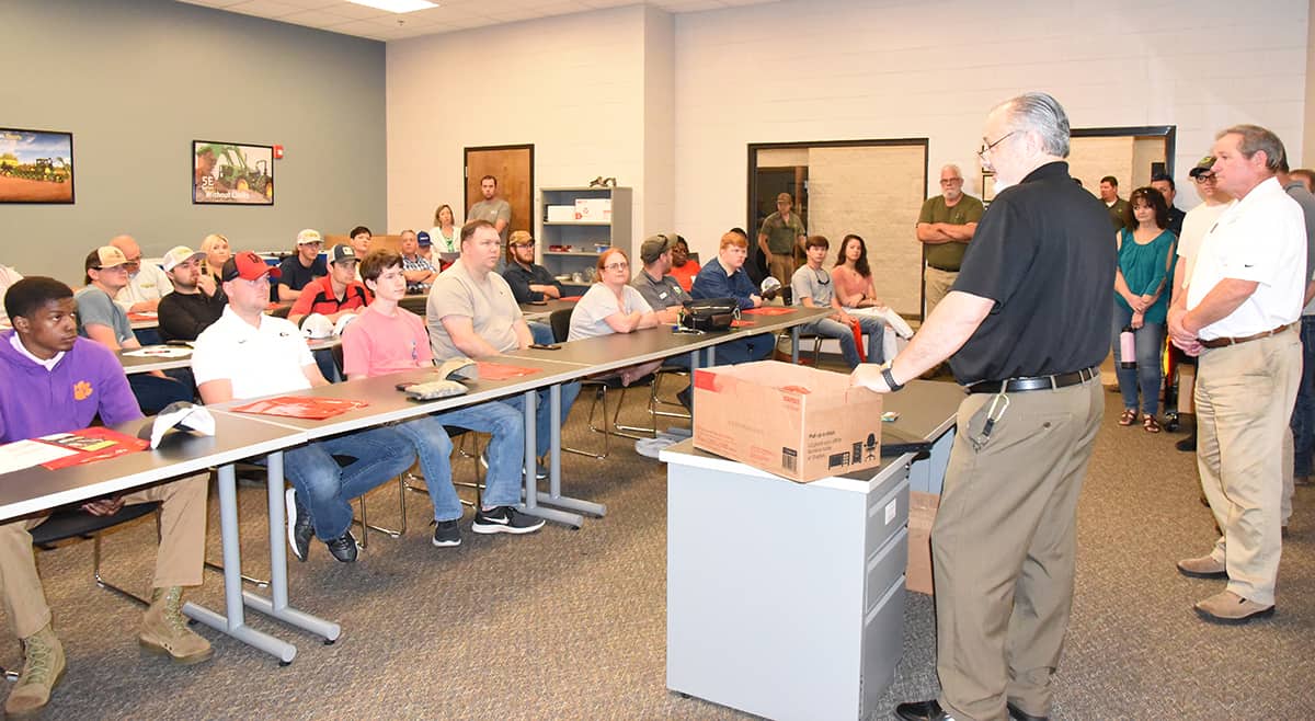 SGTC Dean of Academic Affairs David Finley is shown above talking with students and parents about the John Deere Tech program at SGTC as well as admissions, financial aid, campus housing and campus life activities.