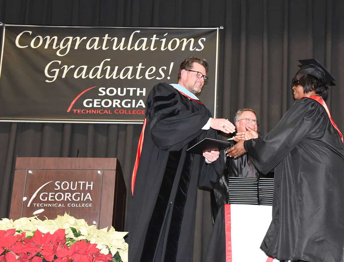 SGTC President Dr. John Watford is shown above presenting a diploma to a student at the Fall 2019 graduation ceremony.