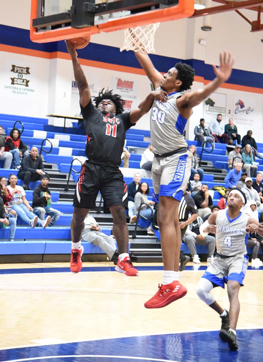 Sophomore Jaylan McKinney, 11, is shown driving in to the basket.