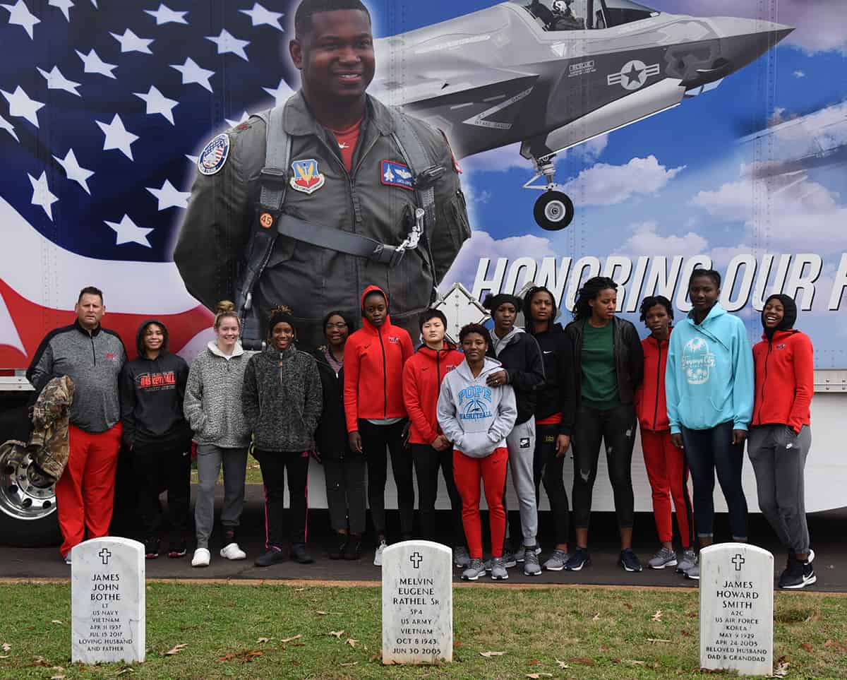 Lady Jets help with placing Wreaths on veterans graves at Andersonville.