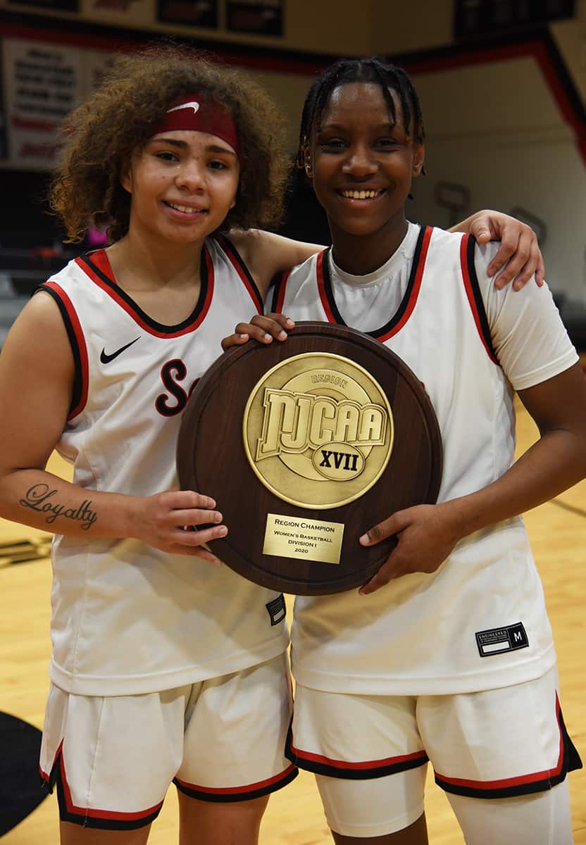 Sophomores Shamari Tyson and Niya Goudelock are shown holding the Region XVII trophy they worked hard to help the Lady Jets achieve.