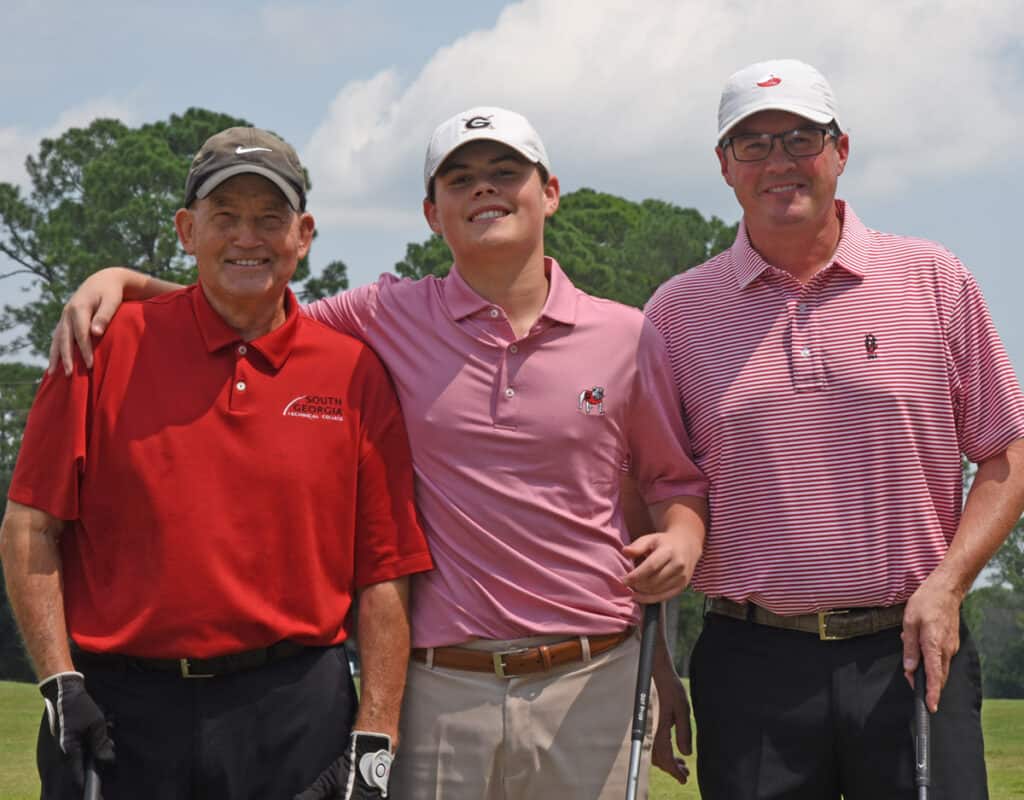 Sparky Reeves is shown above with his grandson Will, and his son, Kevin, getting ready to tee off in the Sparky Reeves Golf Classic.