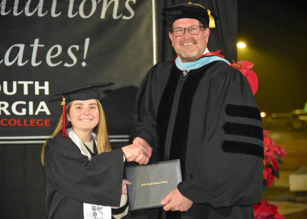 SGTC President Dr. John Watford congratulates graduate Kelli Rees at the recent South Georgia Technical College Fall Commencement ceremony.