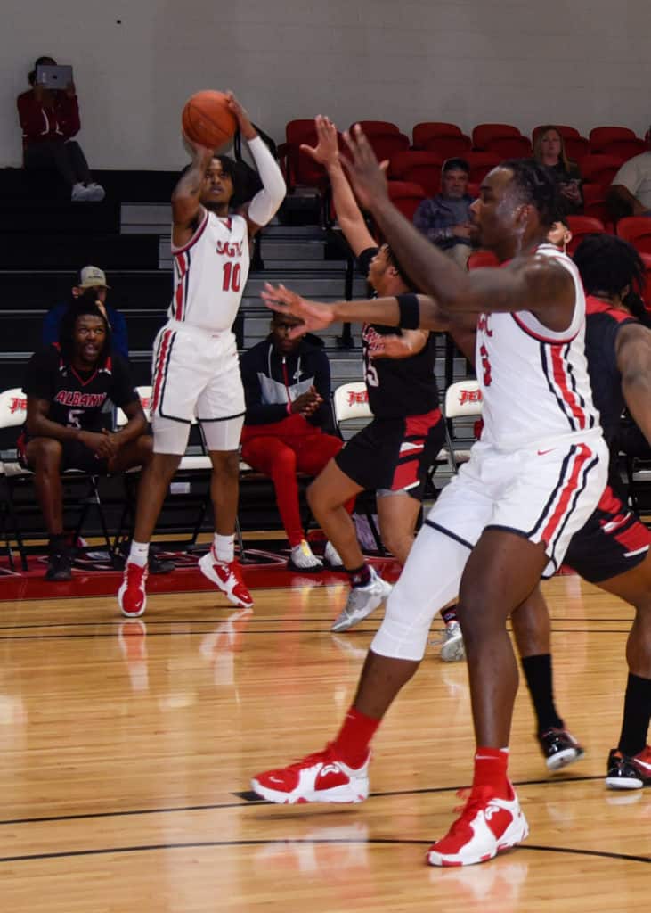 Marvin McGhee gets off a three-point shot for the Jets against Albany Tech.