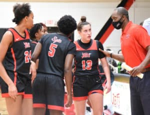 Demetrius Colson is shown above talking with the Lady Jets during a time-out.