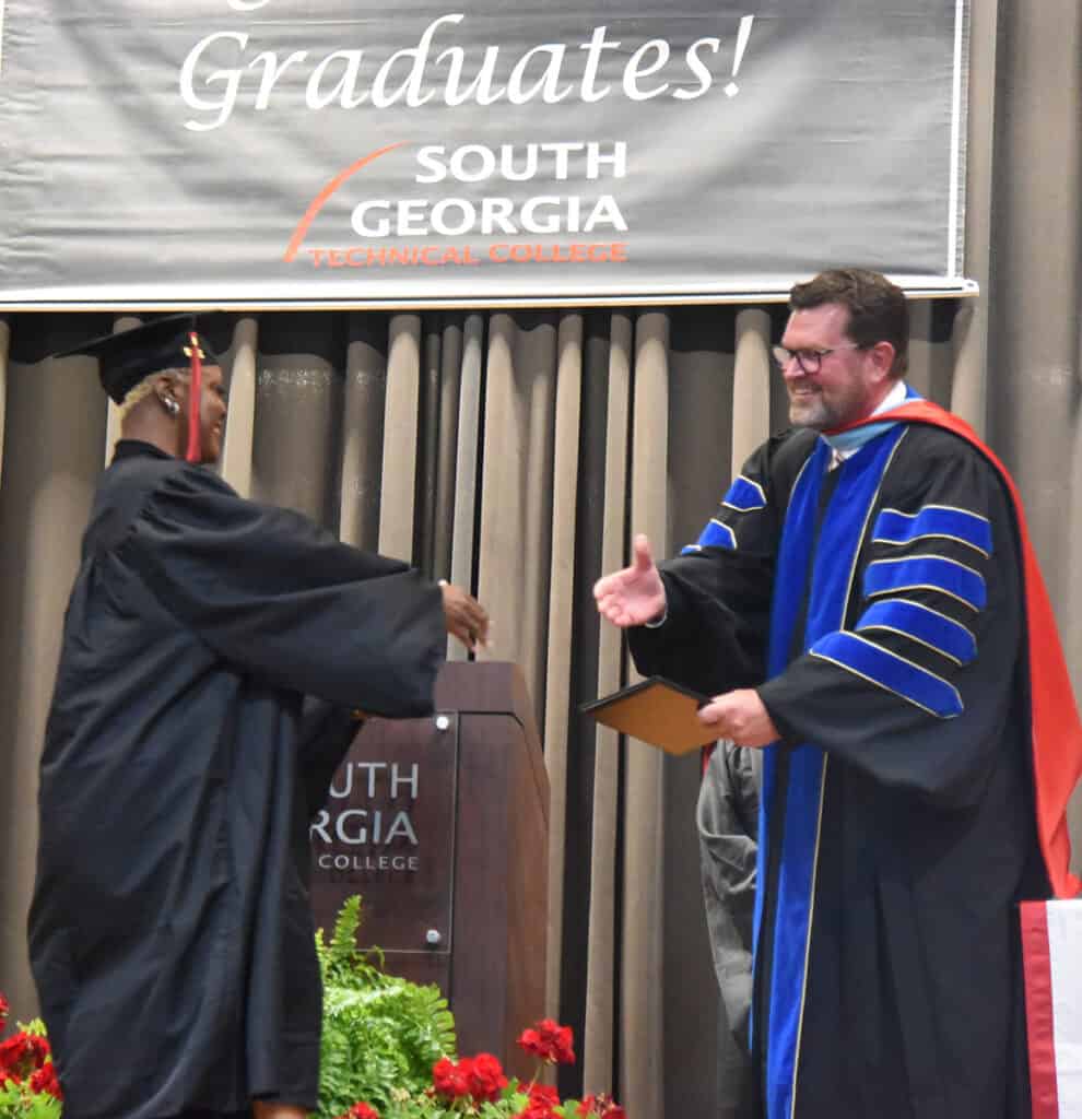 Shannon Daisy Jones of Americus is shown above accepting her Air Conditioning Technology diploma from President Dr. John Watford.