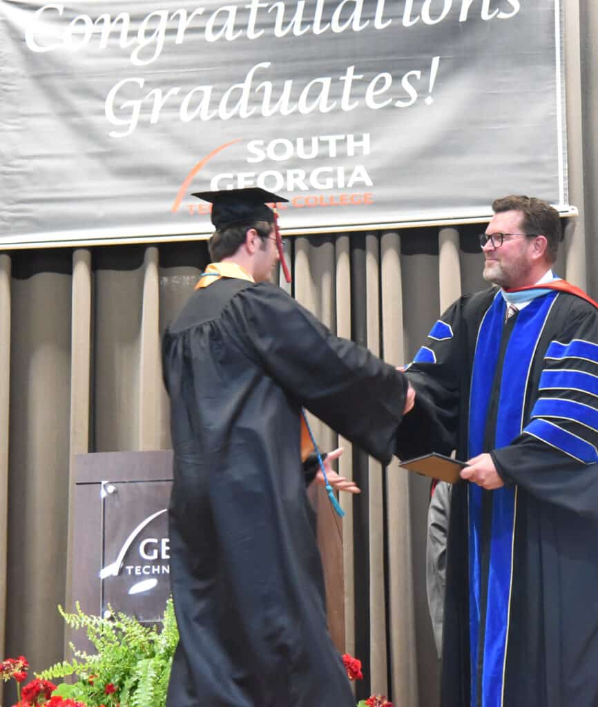 South Georgia Technical College President Dr. John Watford is shown above with Mitchell Turton, a high school student at Southland Academy who earned a diploma in Precision Machining and Manufacturing prior to his high school graduation.  He has been accepted into Georgia Tech this fall where he plans to study engineering.