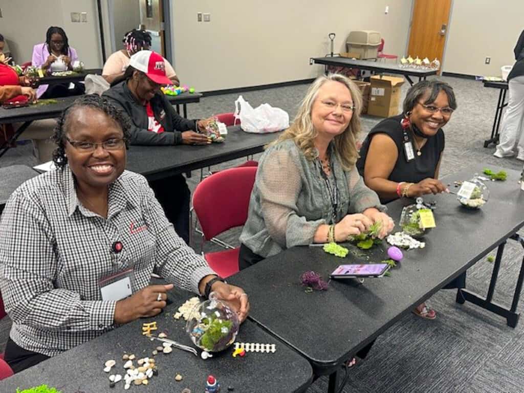 Participants show off their terrarium