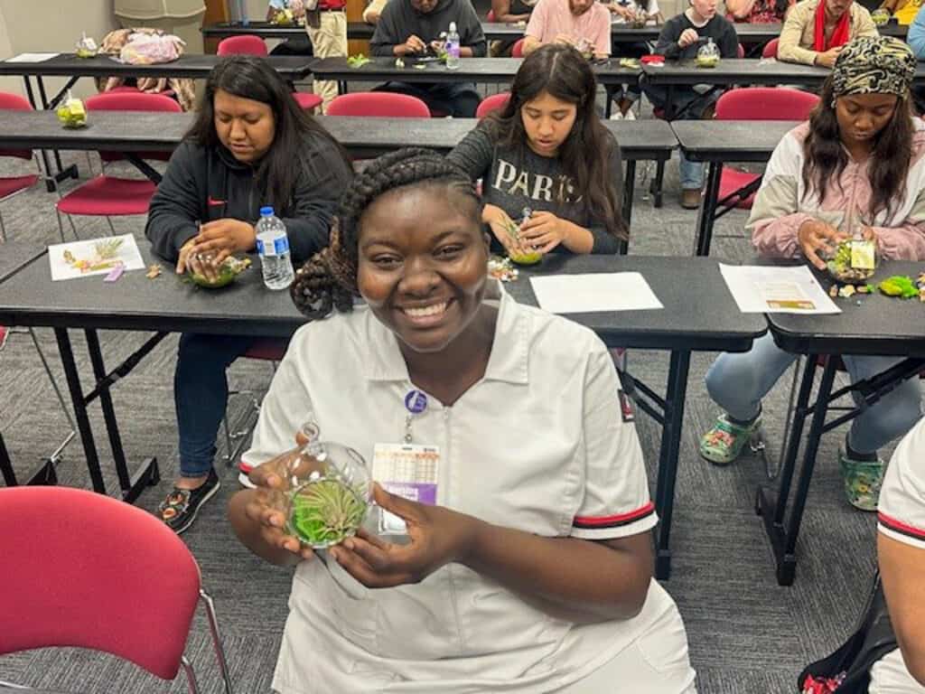 A student show off their terrarium