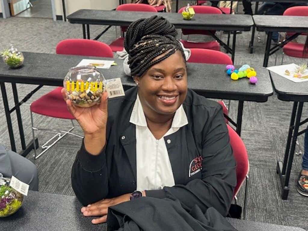 A student show off their terrarium