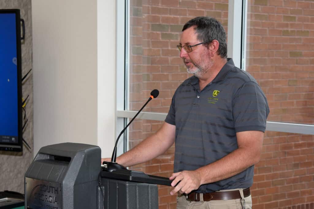 Instructor Matthew Burks speaks at podium