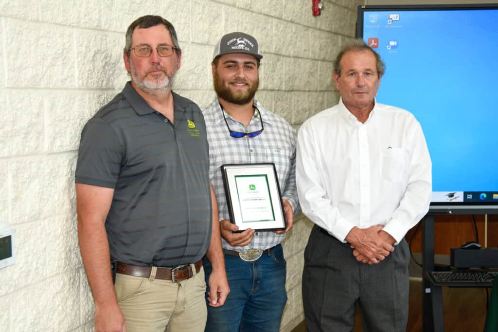 Student Brian Wiley receives plaque