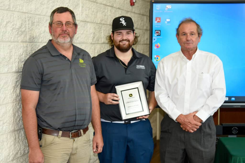 Student Jeremy Pollard receives plaque