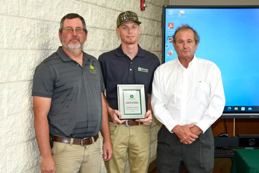 Student Jonathan Mobley receives plaque