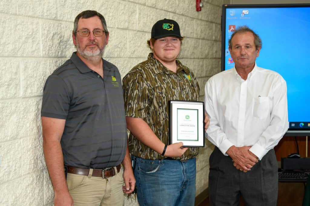 Student Stephen Statham receives plaque