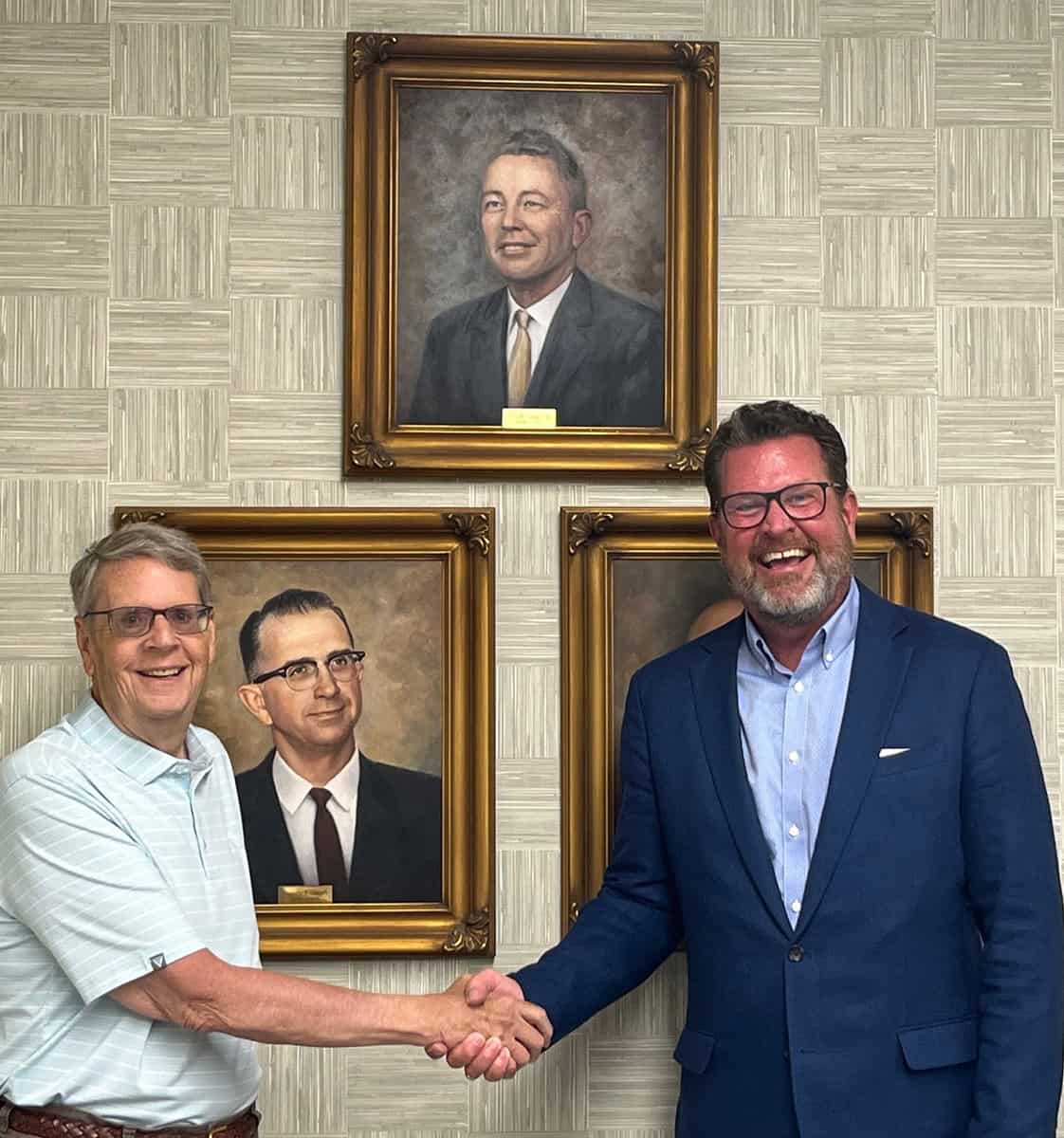 SGTC President Dr. John Watford (right) is shown above with Lofton Odom looking at the Presidential Portrait of his father, Horace Odom, (center top) which hangs in the Odom Center Conference room on the Americus campus.