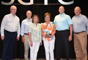 Lillie Ann Winn and her husband Greg (center right) are shown above with her family that attended the retirement reception.