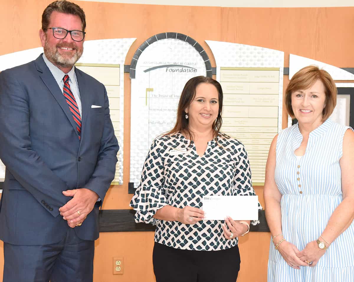 South Georgia Technical College President Dr. John Watford, (l), is shown above accepting a donation for the SGTC Foundation from Marian McLemore, (c) Vice President of Cooperative Communications with Flint Energies. Tami Blount, Partnership Coordinator for the Electrical Lineworker program is also shown (right).